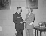 Edward J. McCormick and unidentified man shake hands