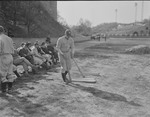 Baseball team members on the bench with batter